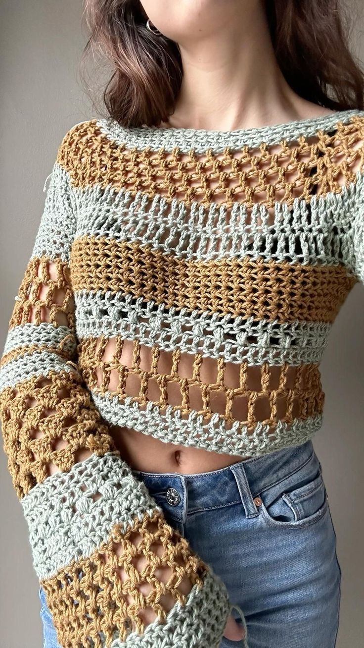 a close up of a person wearing a sweater with crochet on the sleeves