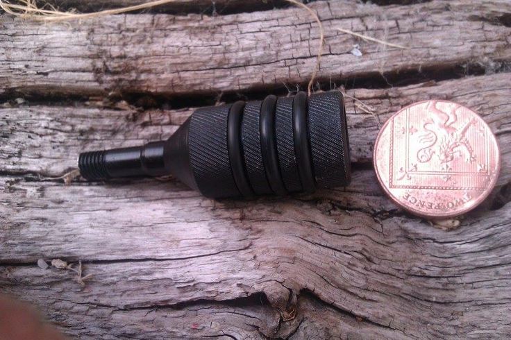 a penny sitting on top of a piece of wood next to an electric wire plug