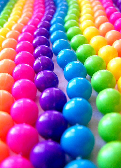 many different colored balls are lined up together