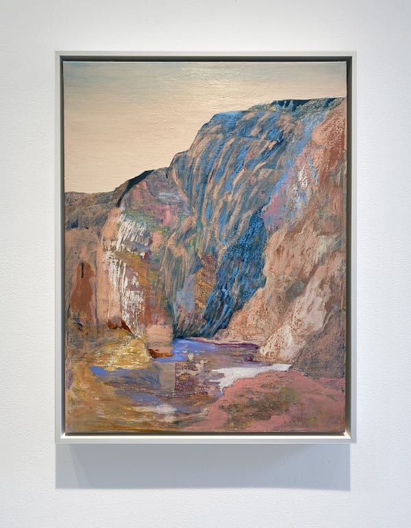 an abstract painting hangs on the wall above a white framed artwork piece with a mountain landscape in the background