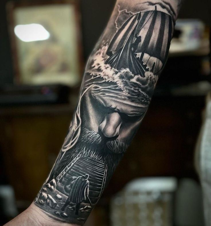 a man's arm with a black and white tattoo on it, depicting the face of jesus