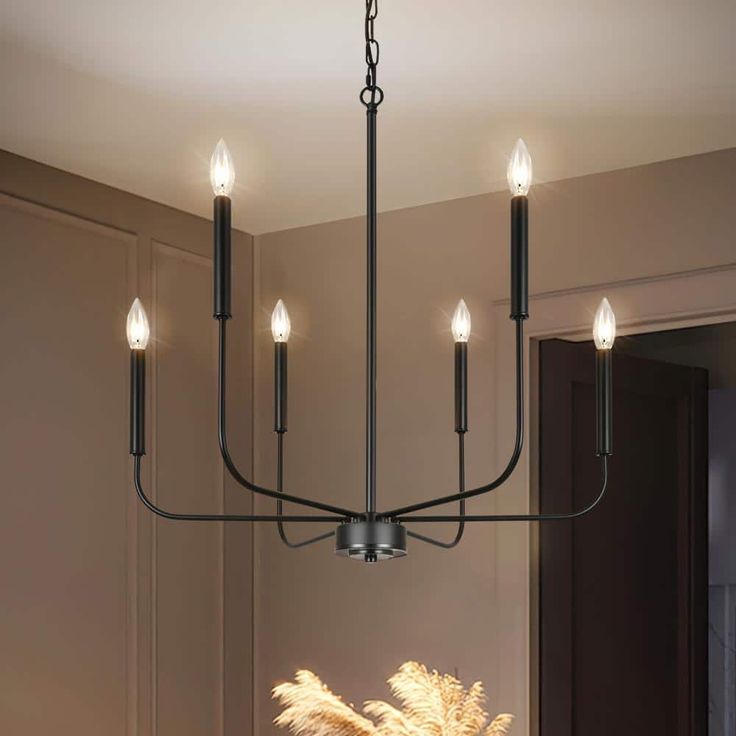 a chandelier hanging from the ceiling in a dining room