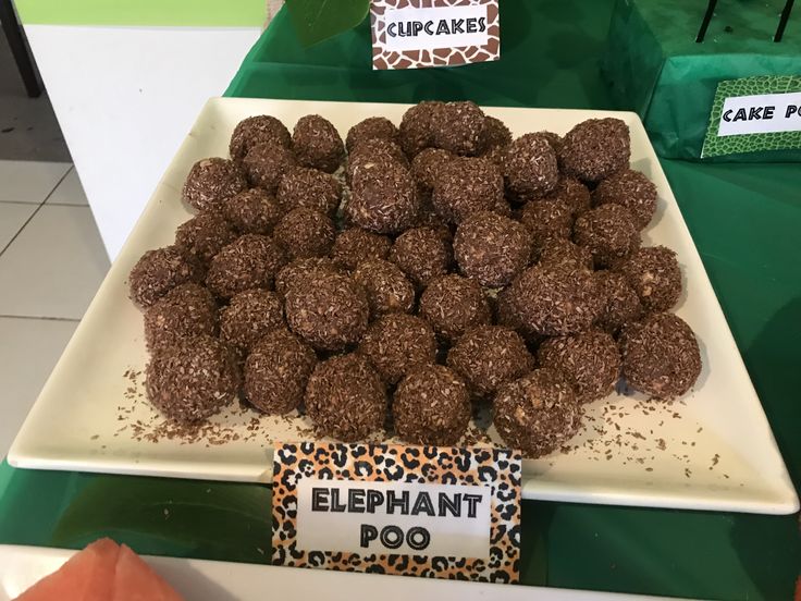 there is a white plate with chocolate balls on it and a sign that says elephant poo