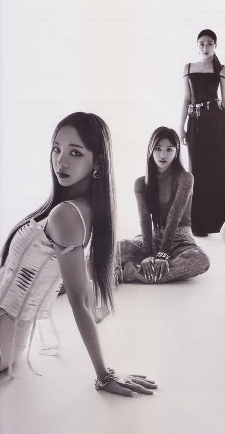 three women sitting on the floor in dresses