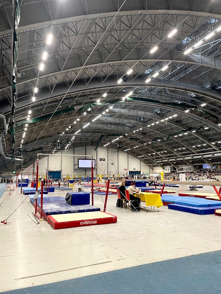 an indoor trampoline facility with people sitting on it