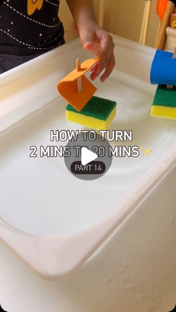 a person is cleaning a sink with sponges and a rag on the edge to clean it