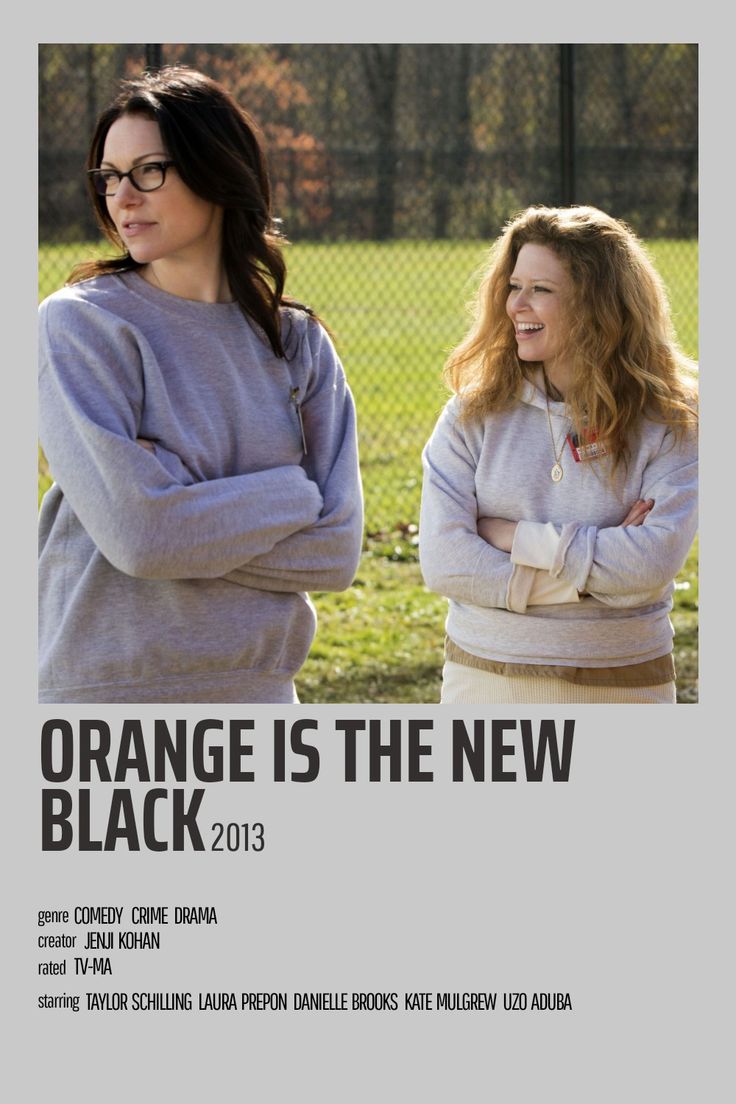 two women standing next to each other in front of a fence with the words orange is the new black