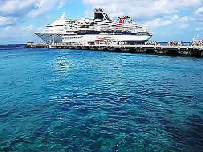 a large cruise ship docked at a pier