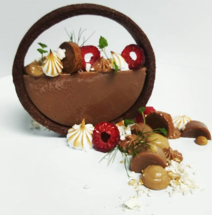 there is a chocolate dessert in the shape of a bowl with strawberries on top