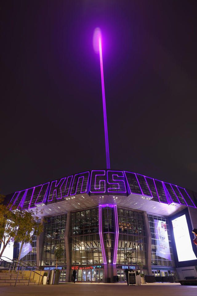 an illuminated building with purple lights on it