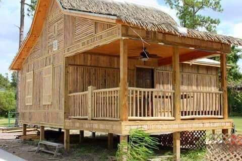 a small wooden house sitting on top of a lush green field