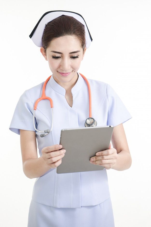 a woman in scrubs holding a tablet computer