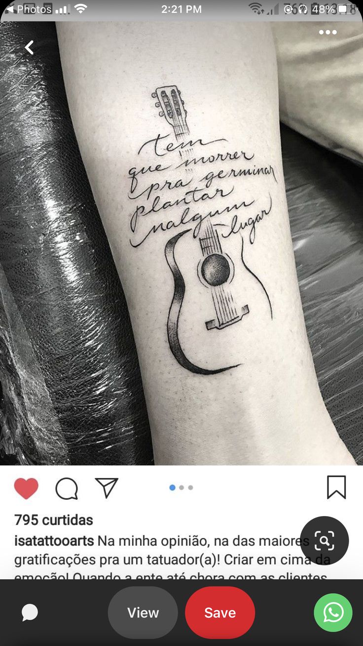 a person with a guitar tattoo on their arm