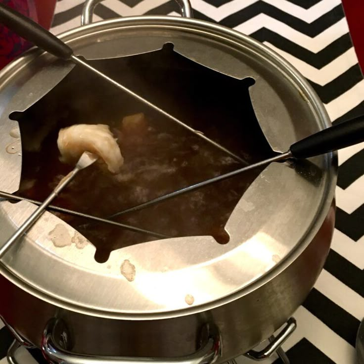 a metal pot filled with food on top of a stove