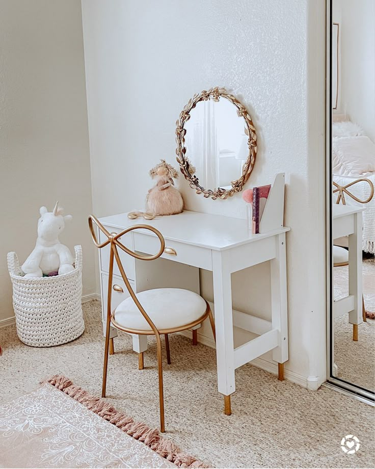 a white desk with a mirror, chair and stuffed animal on it in a room