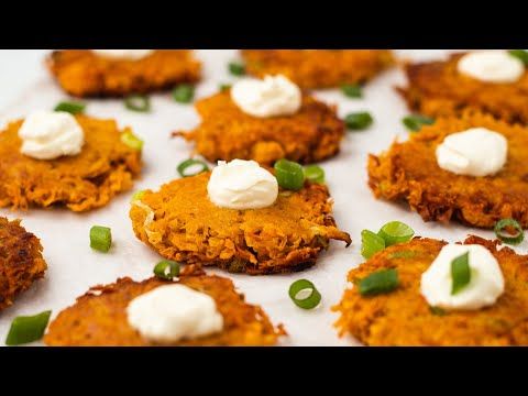 some food is laying out on a white plate with green onions and sour cream toppings