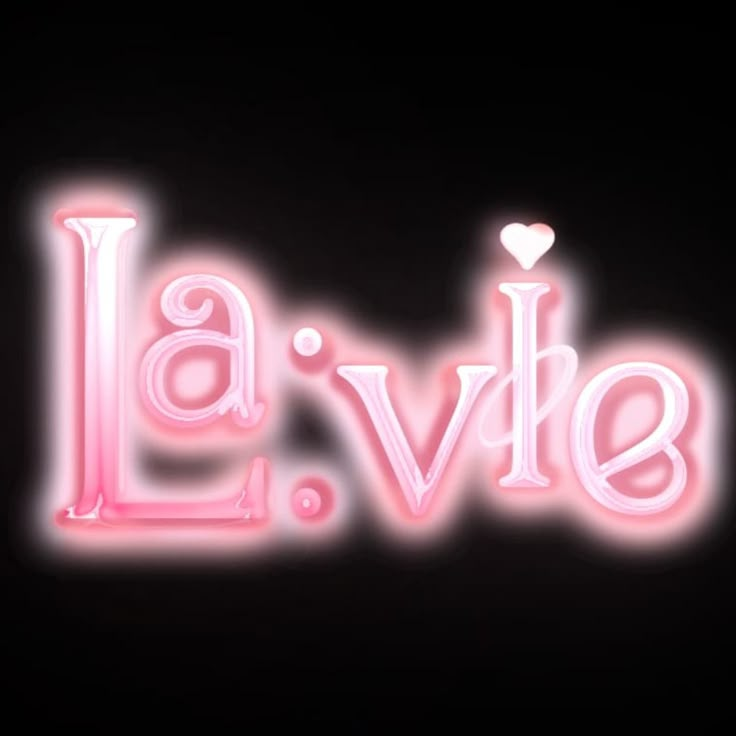 the word la vie is lit up in pink and white letters with a heart on top