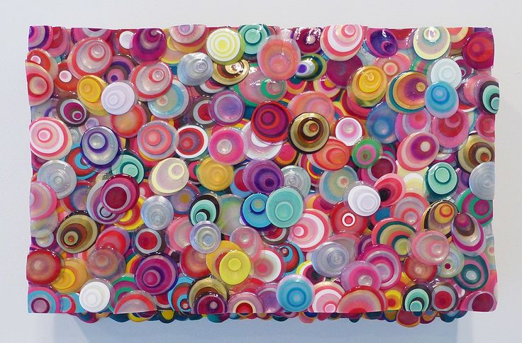 a painting made out of circles on a white wall