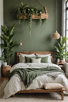 a bedroom with green walls and plants hanging on the wall above the bed, along with a wooden headboard