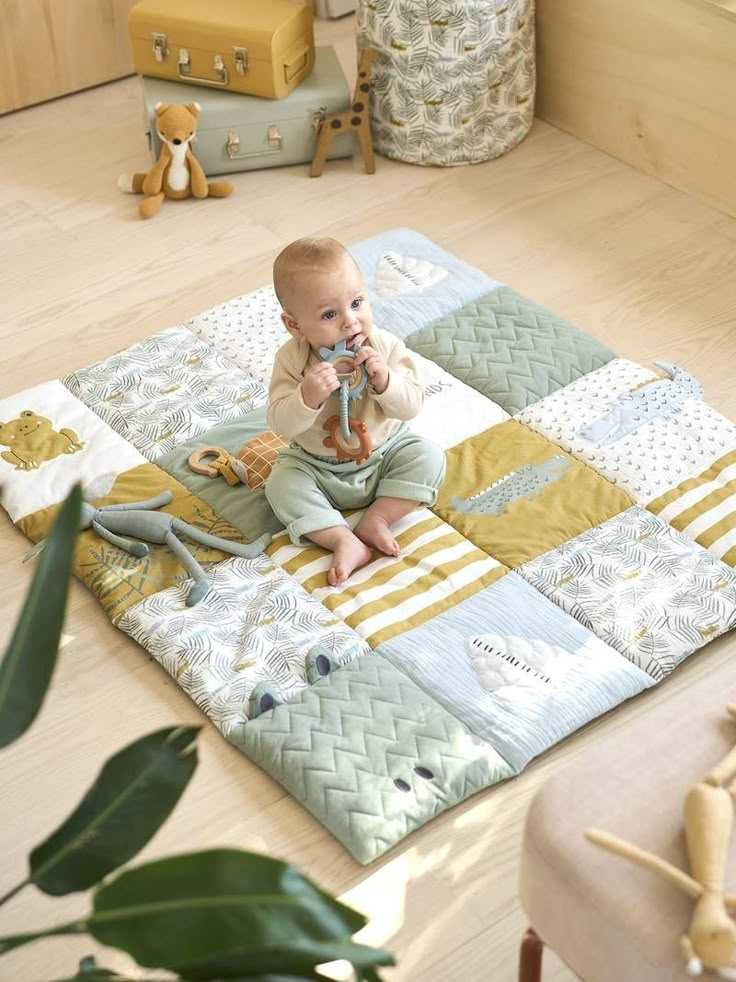 a baby is sitting on the floor playing with a toy in his hands and eating it