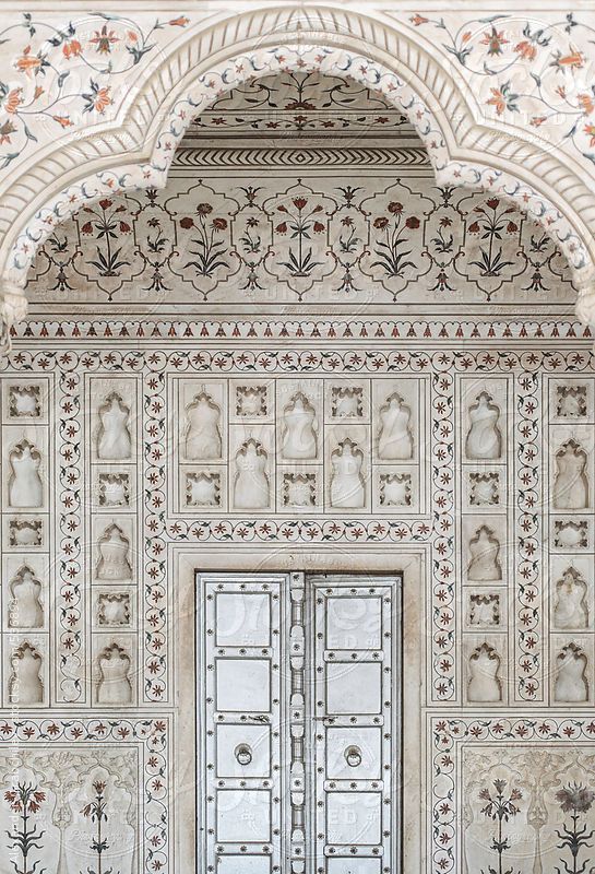 an intricately decorated wall with two doors