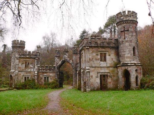 an old castle like building in the woods