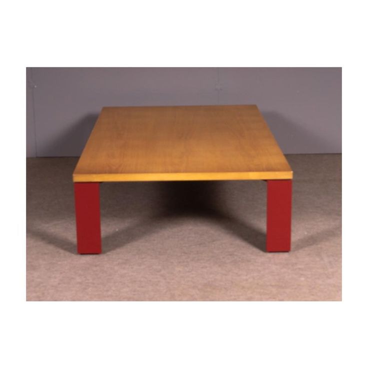 a wooden table sitting on top of a carpeted floor