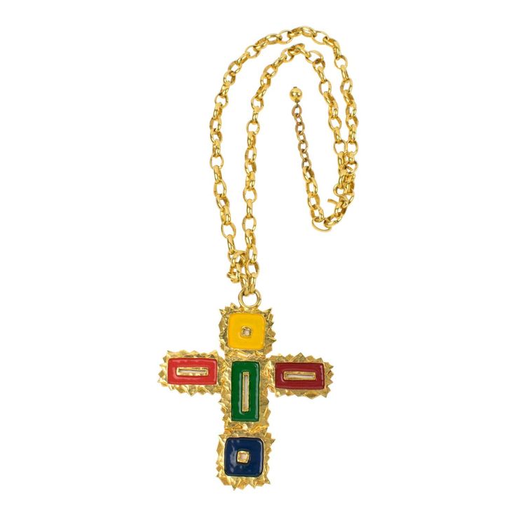 This gorgeous Mercedes Robirosa Paris couture pendant necklace features an oversized gilt metal all-textured and pierced cross pendant ornate with enamel in red, green, blue, and yellow. The heavy gilded metal chain has a hook-closing clasp and chain for length flexibility. The signature is engraved on the underside of the pendant: Mercedes Robirosa. Measurements: Necklace total length is 31.10 in (79 cm) - drop is 18.50 in long (47 cm) - pendant is 3.44 in wide (8.7 cm) x 3.98 in high (10.1 cm) Enamel Cross, Silk Necklace, Paris Couture, Pearl Chain Necklace, Chanel Couture, Cameo Pendant, Beaded Choker Necklace, Geometric Pendant, Chain Necklaces