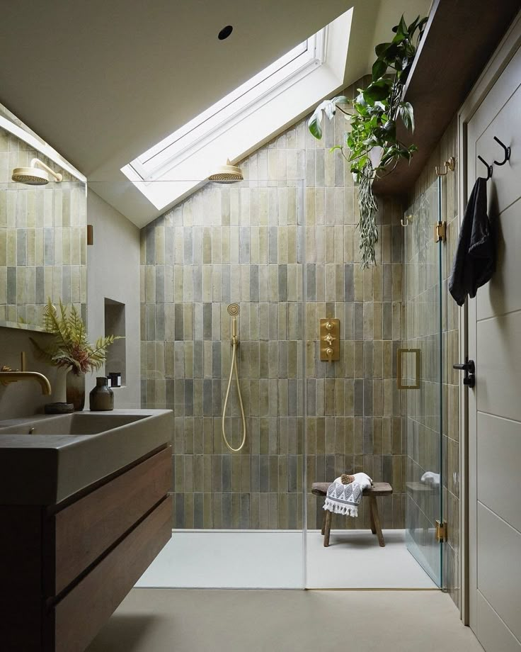 a bathroom with a skylight above the sink and shower area in front of it