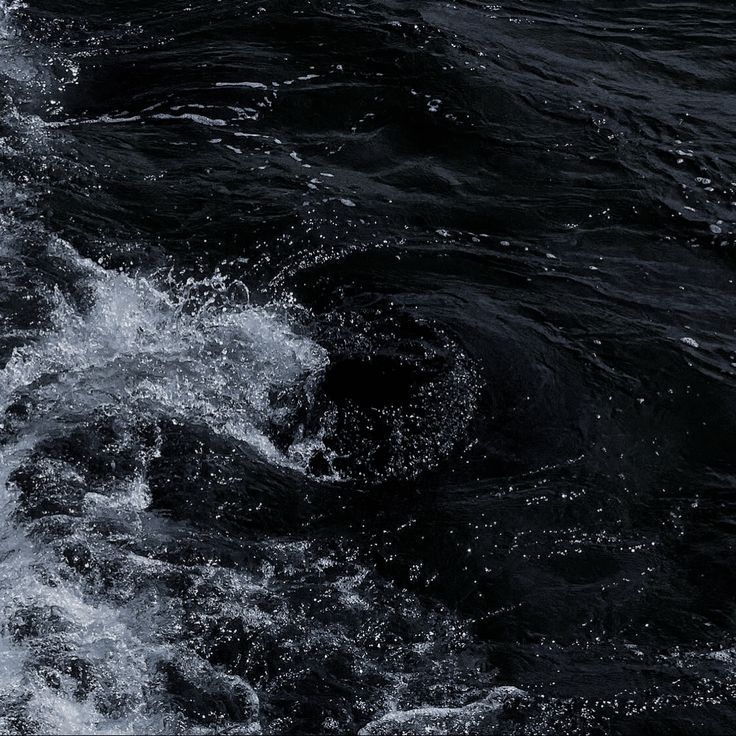 the back end of a boat in rough water