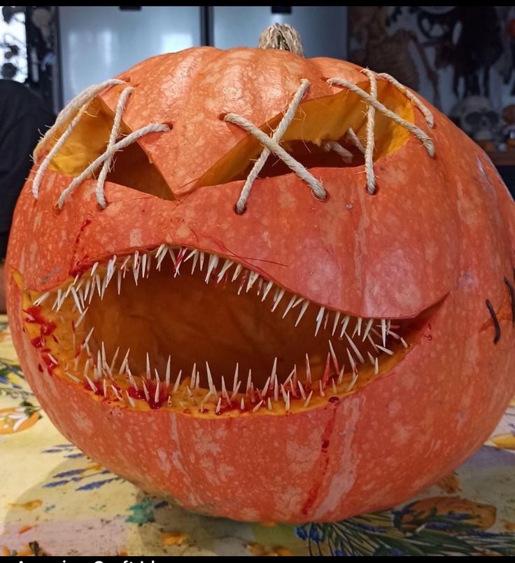 a carved pumpkin with spikes and teeth on it