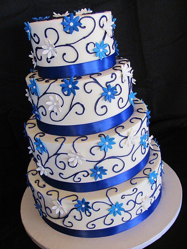 a three tiered cake with blue and white decorations