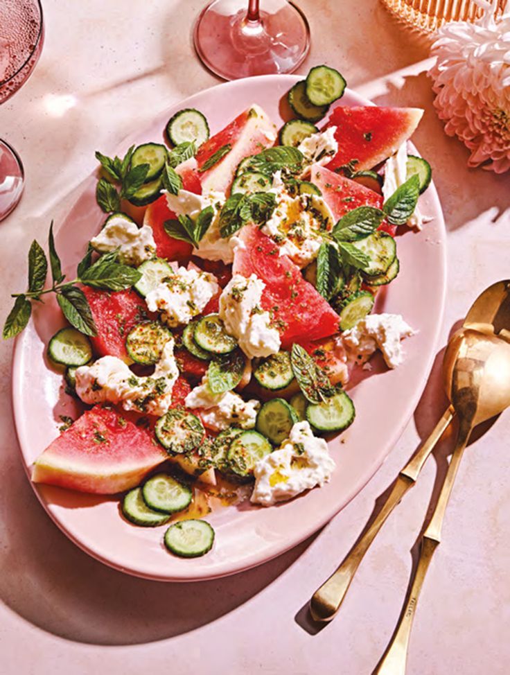 watermelon, cucumber and feta salad on a pink plate