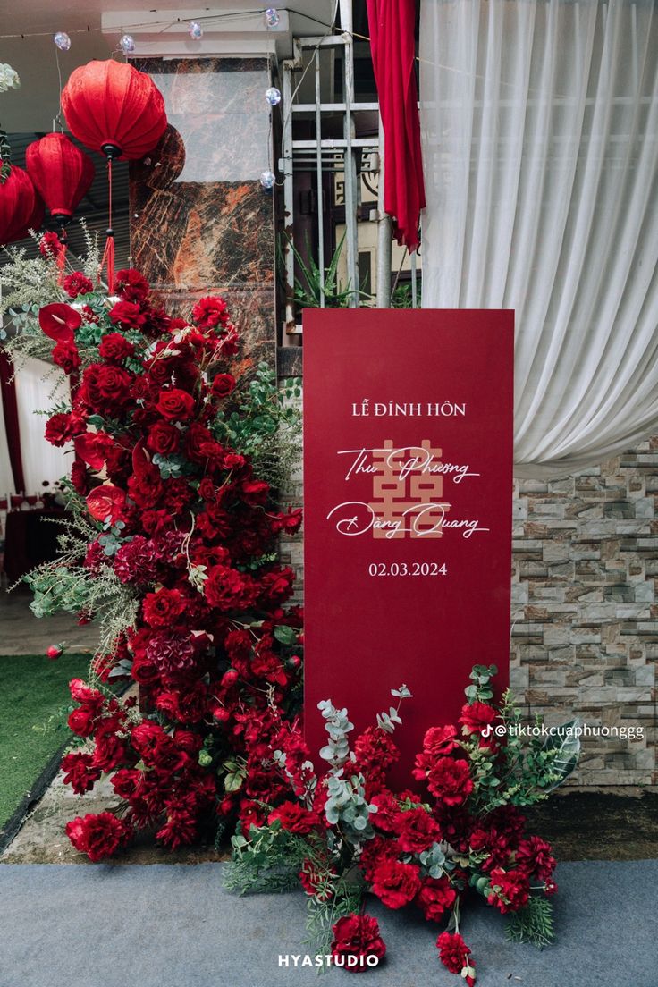 red flowers are on display in front of a sign for the chinese new year celebration