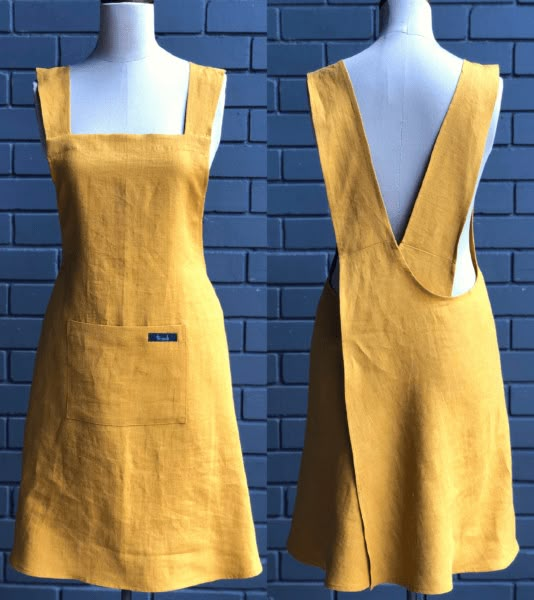 two mannequins are standing next to each other on a blue brick wall