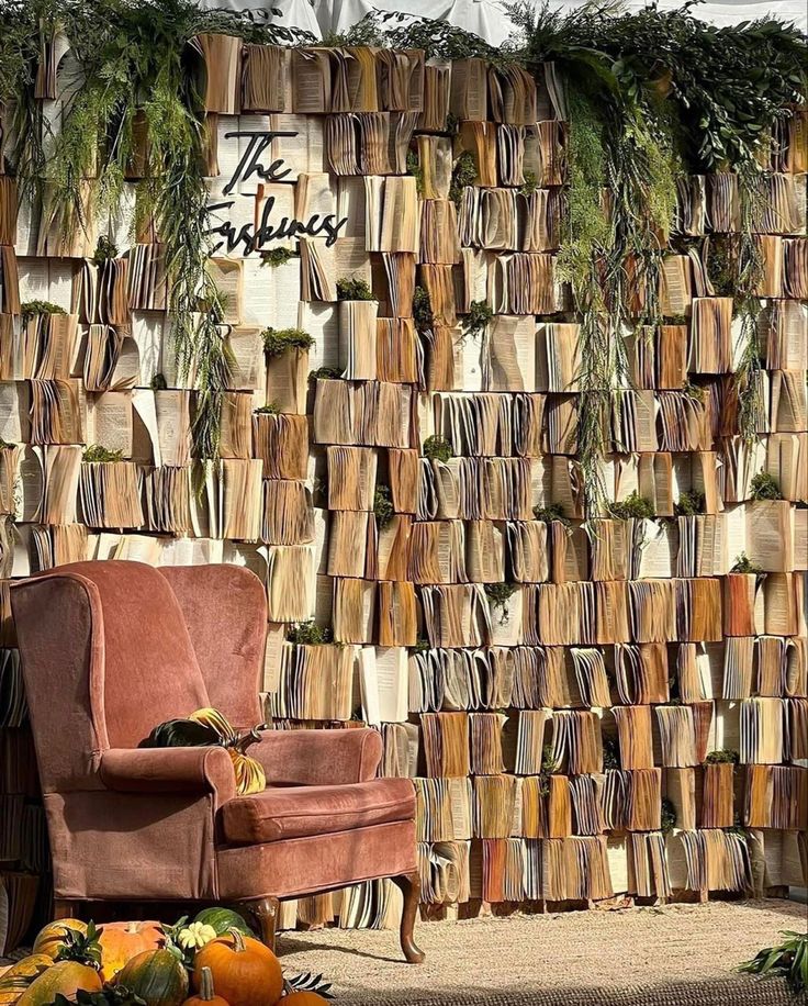 a chair sitting in front of a wall made out of books