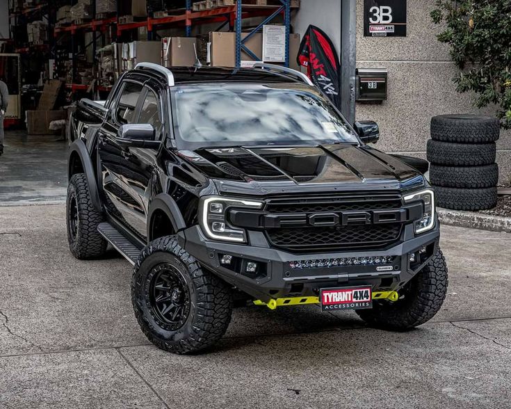 a black truck parked in front of a building