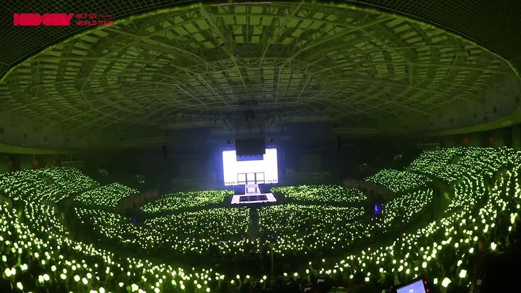 a large room filled with lots of green lights