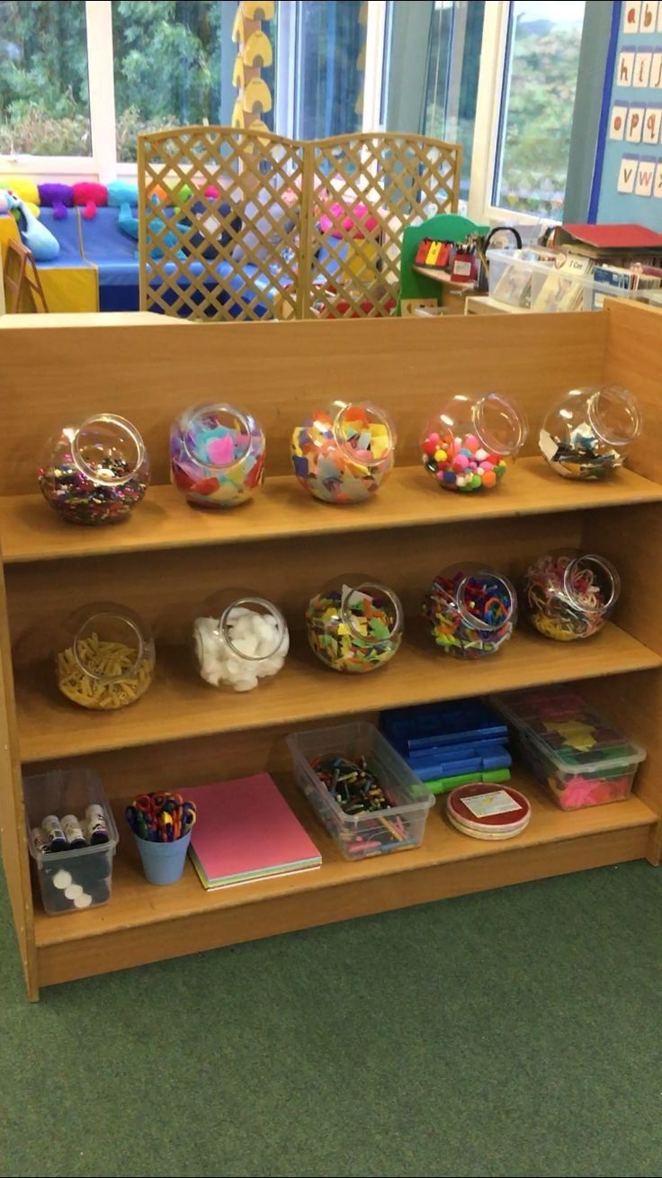 a wooden shelf filled with lots of toys