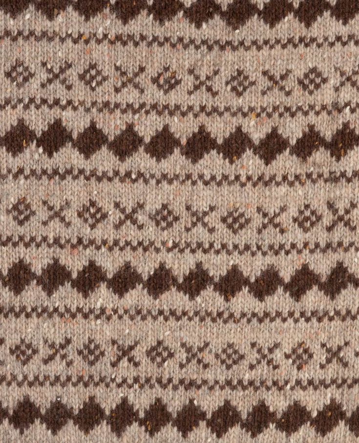 a brown and white knitted sweater with an interesting pattern