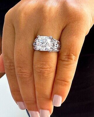 a woman's hand with a diamond ring on it