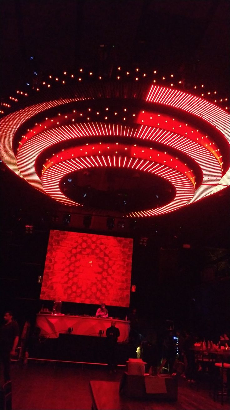 the ceiling is lit up with red lights and circular circles on it's sides