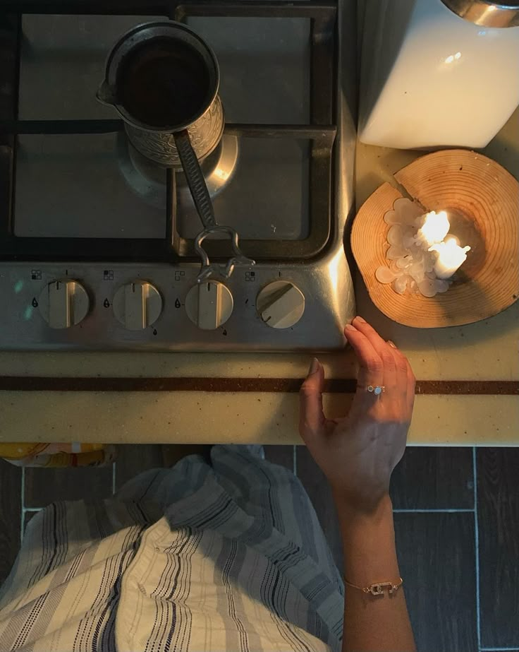 a person reaching for something on the stove