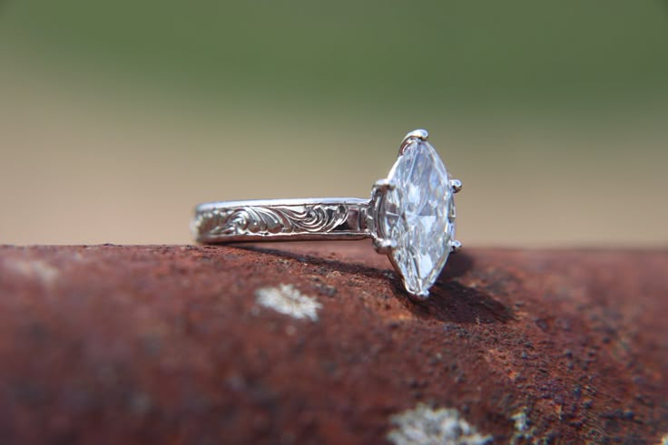 a close up of a ring on top of a rock