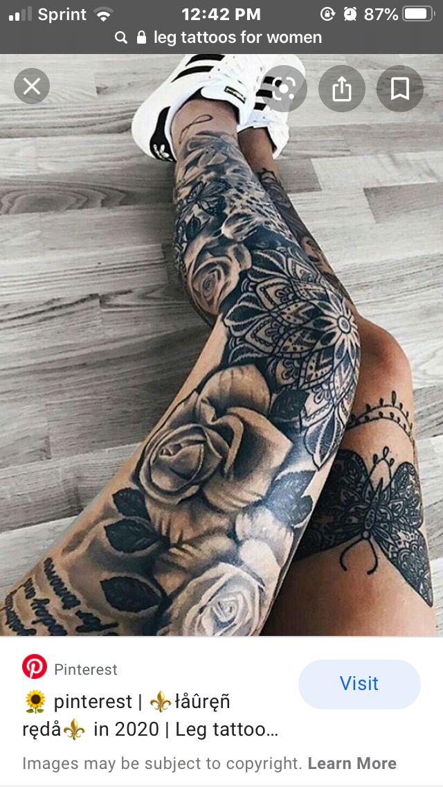 a woman's legs with tattoos on them and flowers in the middle of her leg