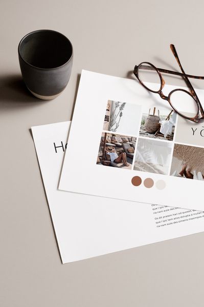 a pair of glasses sitting on top of a table next to papers and a cup