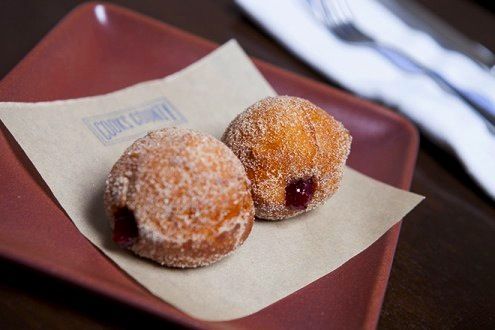 two donuts sitting on top of a red plate