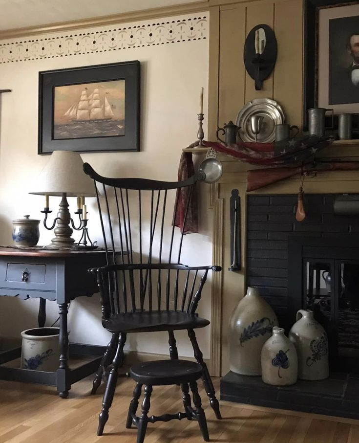 an old fashioned chair sits in front of a fireplace