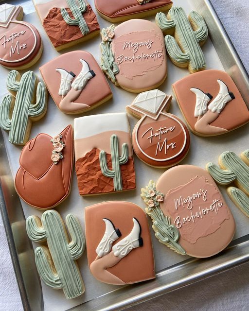 decorated cookies in the shape of cactus and doves on a tray with happy mother's day written on them