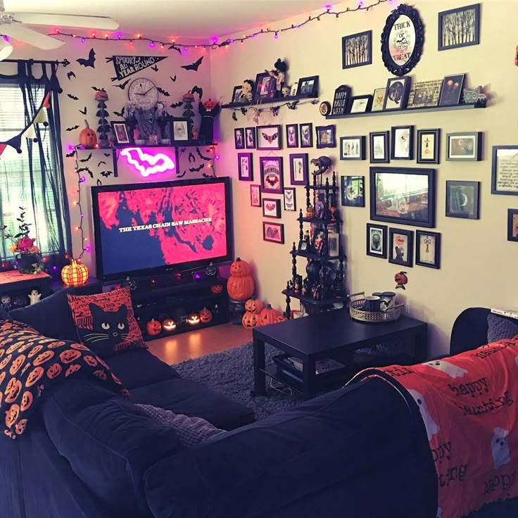 a living room decorated for halloween with decorations on the walls and a flat screen tv